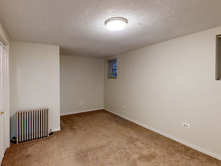 Large bedroom with separate off-season storage area and wall of closet space
