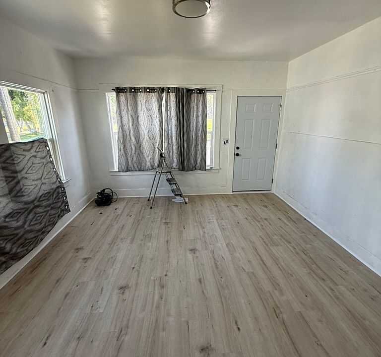 Living room - new floors, paint, door, security door, and light fixture.