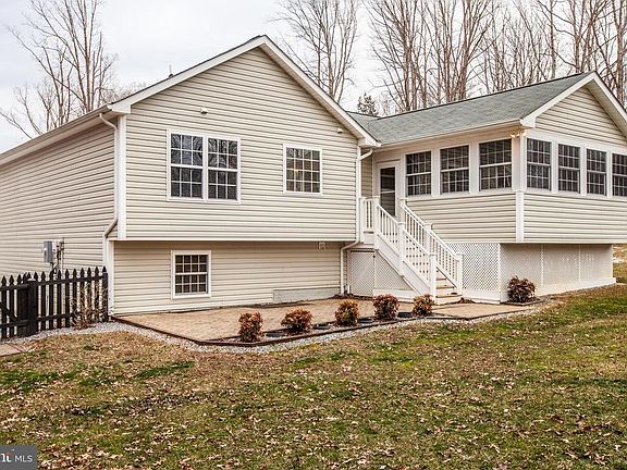 View of the back of the home showing the sun porch