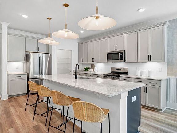 Beautiful open kitchen with bright, warm lighting and a large island.