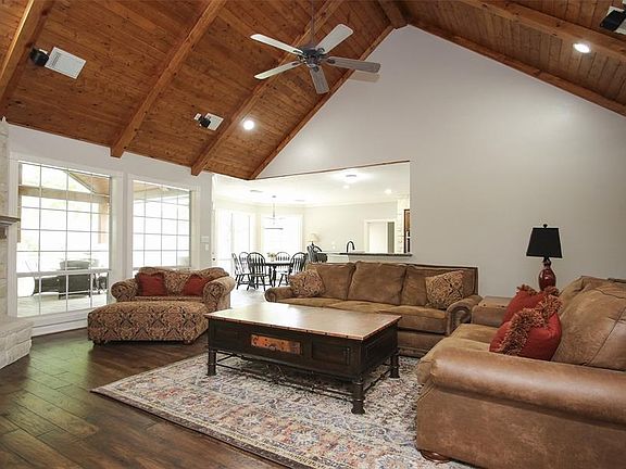 Vaulted wood ceiling plus stone Floor to ceiling fireplace! Wood floors! Built in entertainment center.