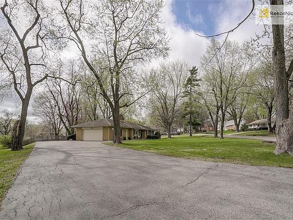Mature trees, expansive driveway offer plenty of shaded parking while entertaining