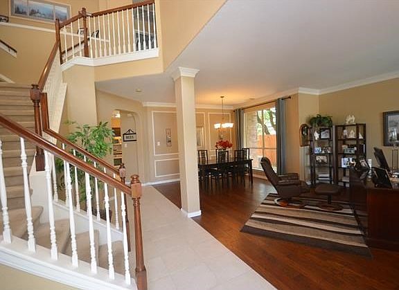 First look as you enter the front door. Beautiful hardwoods in living areas recently installed and stair bannisters stained to match the hardwoods.