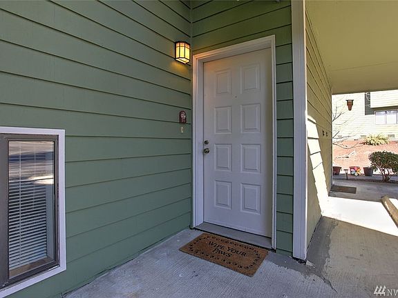 Access to this home is just off of the carport under a covered portico. 