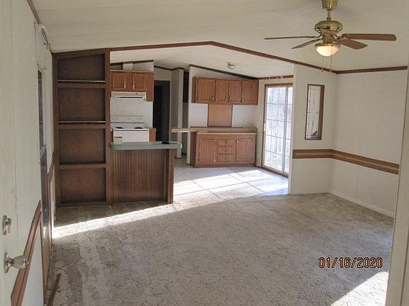 View of living room and kitchen from front door.