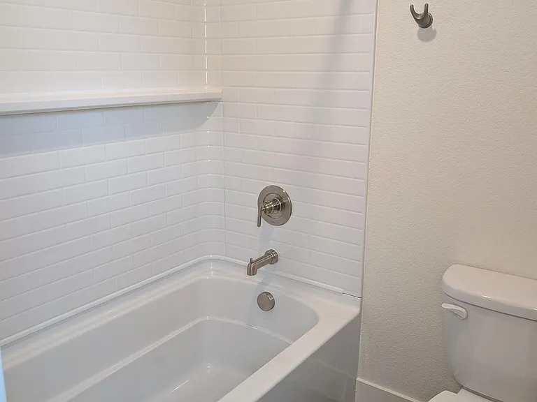 Shared upstairs bathroom with deep tub, and door seperation from sink area