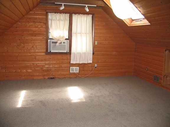 Large Master Bedroom featuring new wall to wall carpeting and skylights!