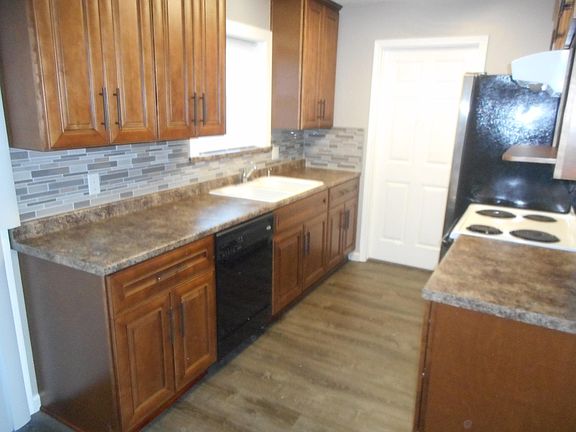 Electric Stove/ oven , vent hood . Upper cabinet to right si