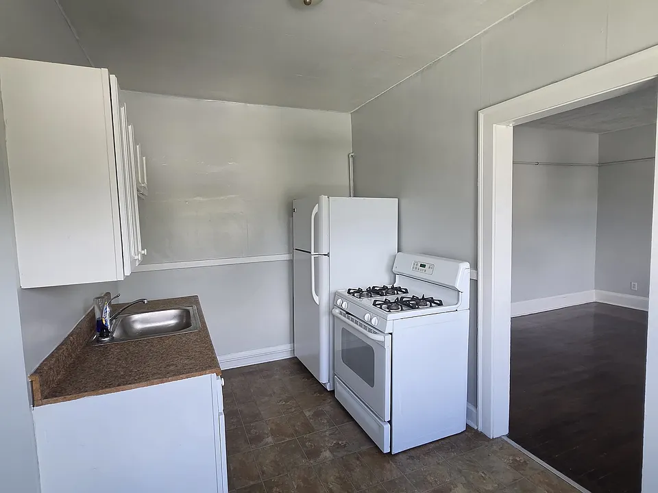 The kitchen offers a refrigerator and stove.