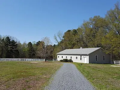 Five stall barn with a foaling stall, tack room, feed room, and wash area.