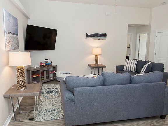 Relax and unwind in our cozy family room, the perfect spot to gather and enjoy. With a large HDTV for movie nights, comfy seating, and a collection of kids' books, it's ideal for both adults and children to relax and enjoy downtime together.