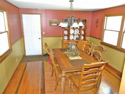 Dining room with inlaid two-tone wood floor