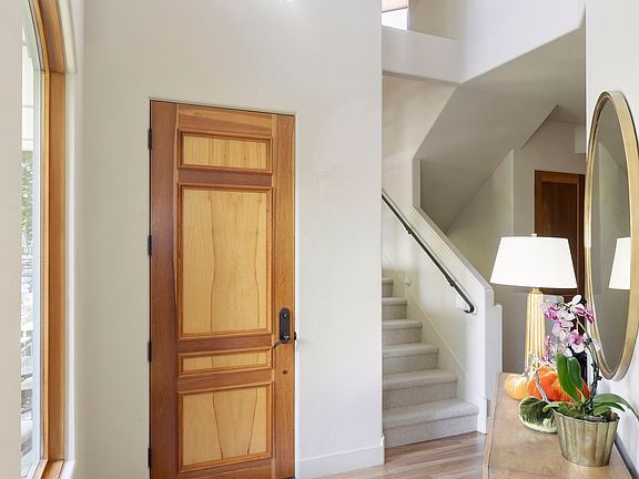 Step into this lovely entryway with soaring ceilings and an inviting main level