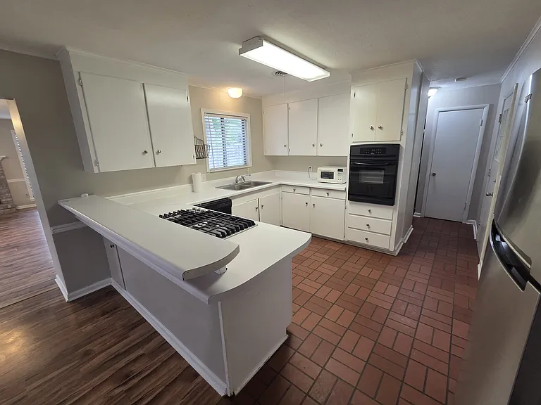Kitchen with oven and refrigerator.