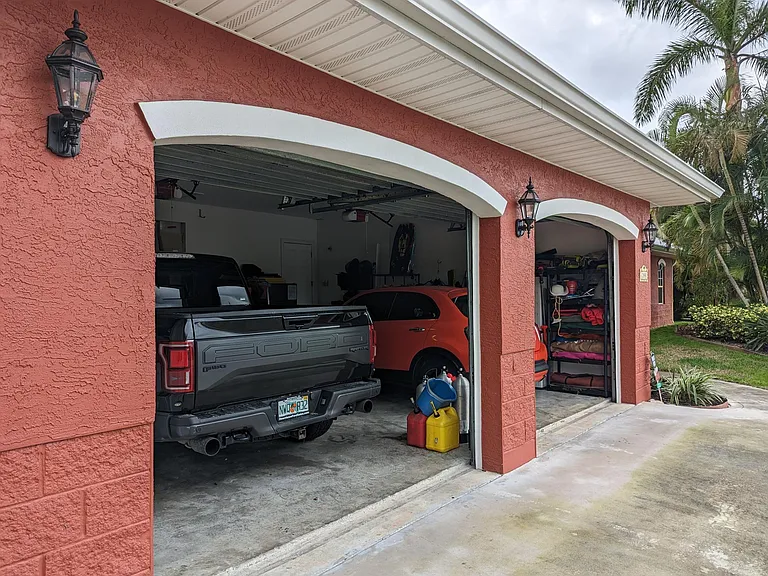 Oversized two-car garage. It currently holds a large truck, compact car and touring Harley with leftover space for an extra fridge and storage. Attic space over the garage is accessed by a pull-down staircase.