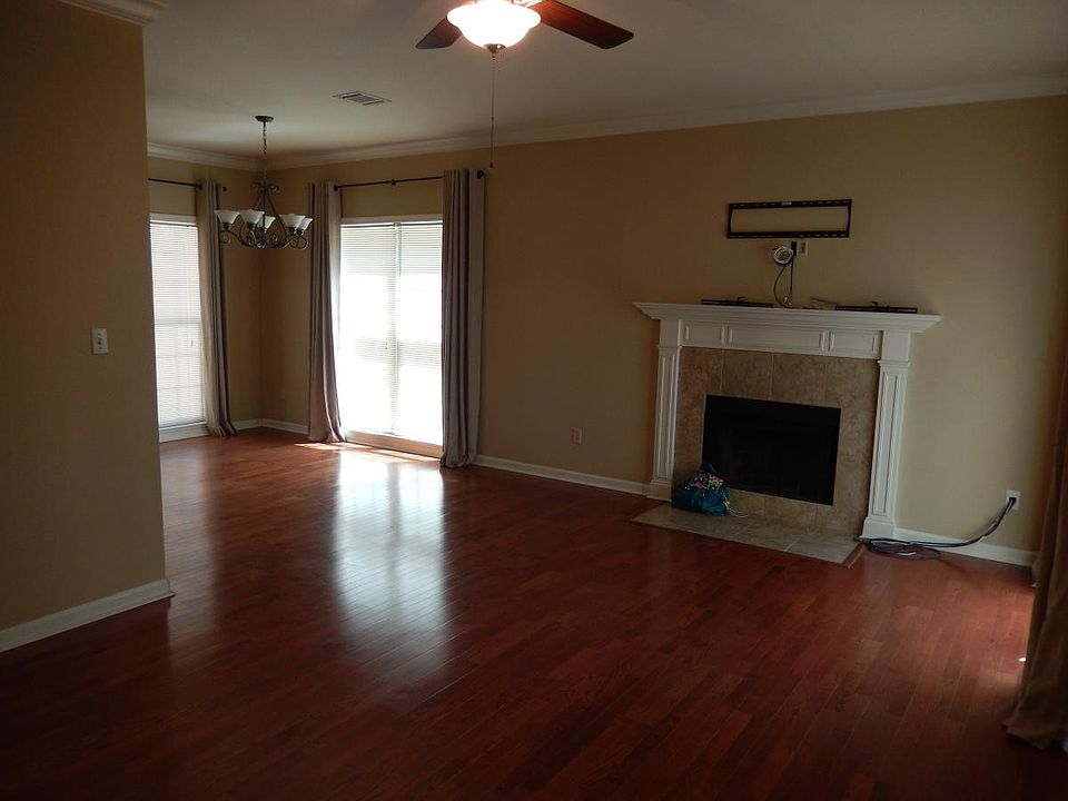 Large open living space with woodburning fireplace, wood bli