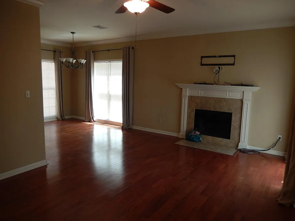 Large open living space with woodburning fireplace, wood bli