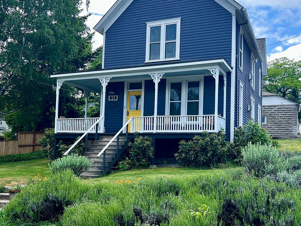 Yellow door entrance to upstairs unit.