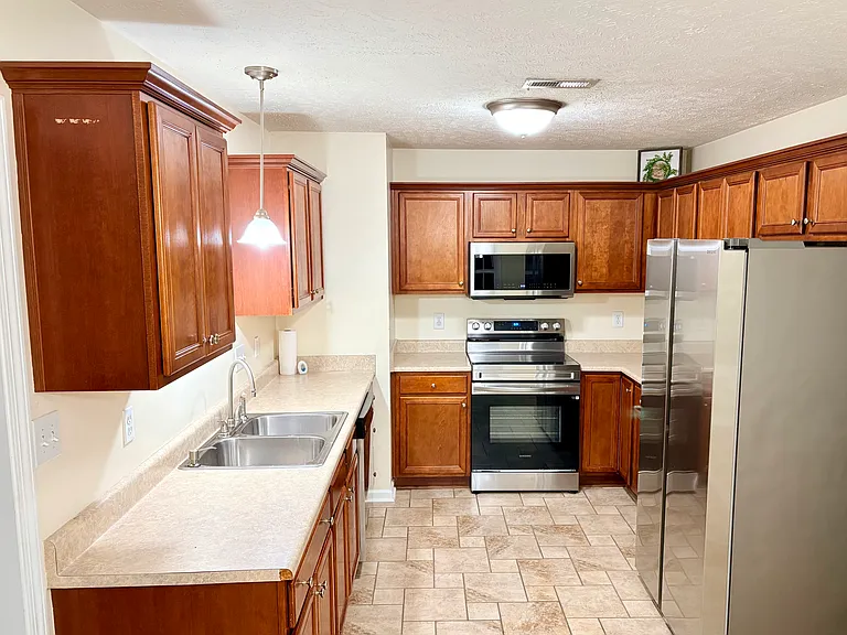 spacious kitchen with stainless steel new appliances