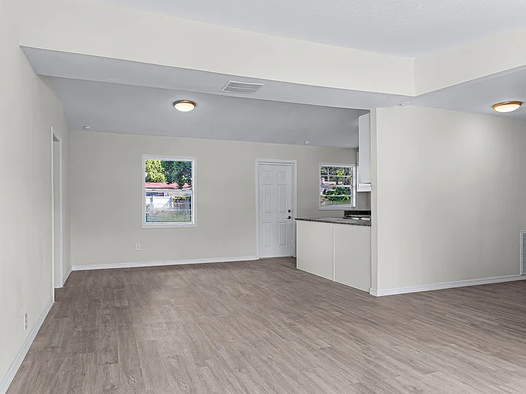 View of dining area next to the kitchen and door leading to the backyard.