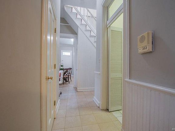 Hallway to laundry room, half bath, stairs to 2nd floor and kitchen
