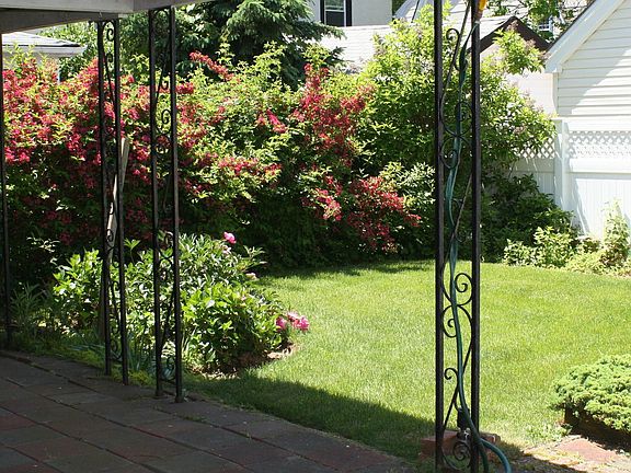 Beautifully landscaped yard with covered patio
