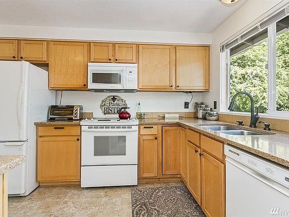 Great kitchen with plenty of cabinets and quartz countertops.