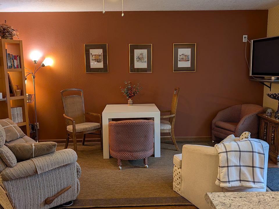 Living area with a reclining couch on each end. Dining table and chairs.