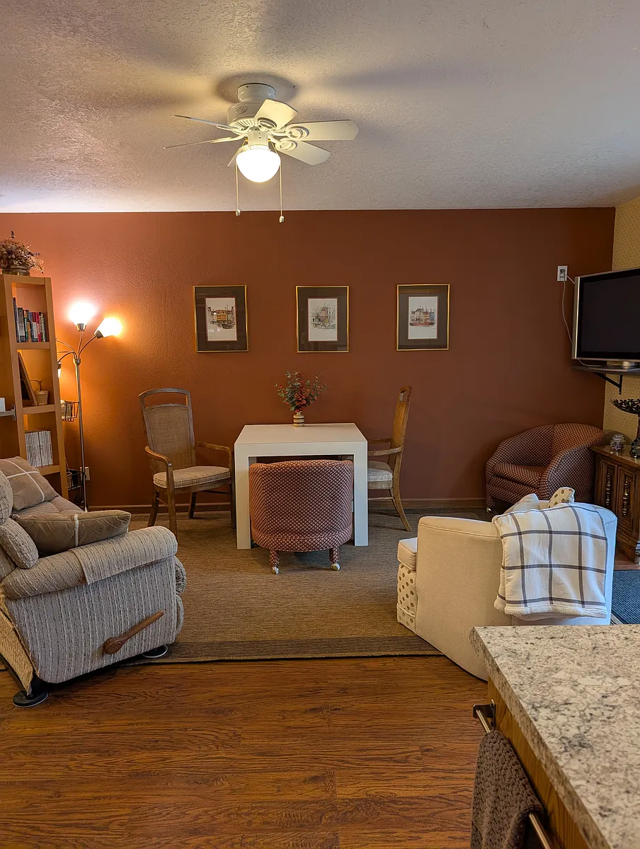 Living area with a reclining couch on each end. Dining table and chairs. - 2466 Saddle Ct