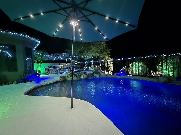 Backyard _ Feel the difference in your skin and swim in the Saltwater pebble-tec pool with two lagoons that allow umbrellas for additional shade. Soak in the 8-person spa with a beautiful waterfall feature.