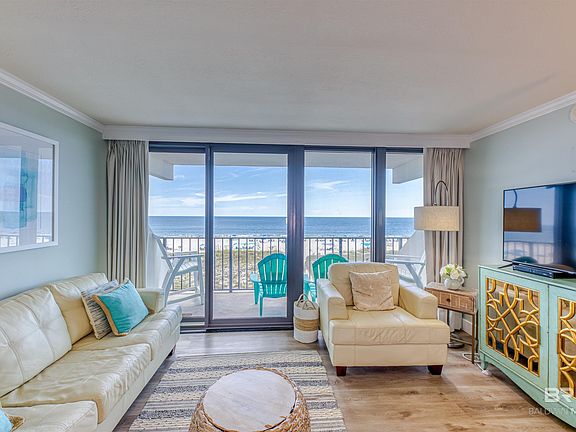 Living room with hardwood / wood-style flooring and crown molding