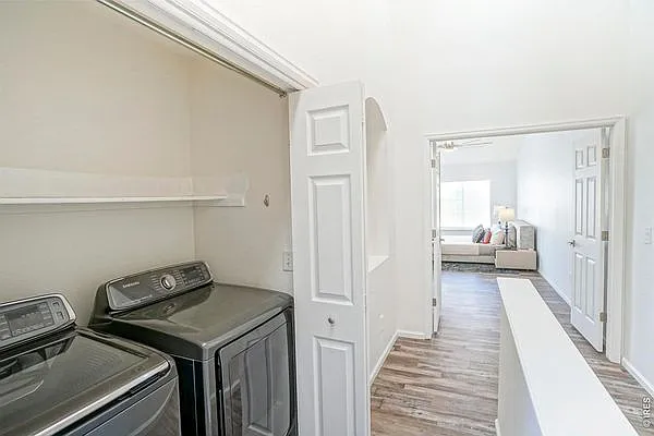 View of Upstairs Laundry with Primary Suite in background (not picture from actual unit)