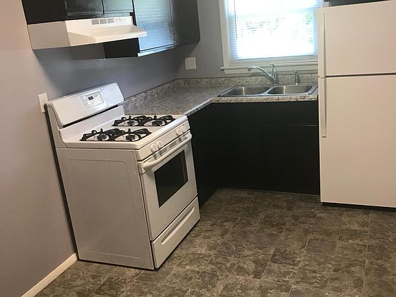 New counters, sink, refrigerator, floor, lighting, range hood and cabinet refresh