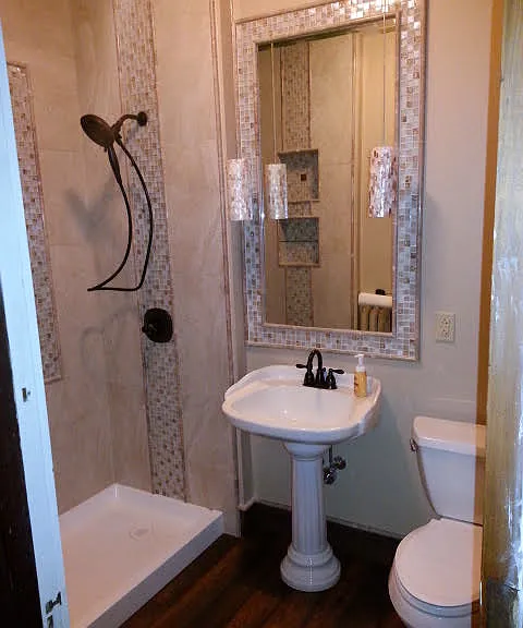 Remodeled en-suite bathroom with custom tile provides a spa-like environment at home.