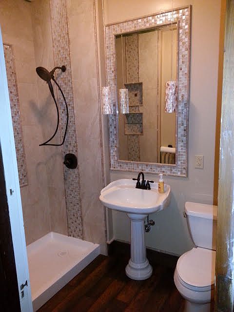 Remodeled en-suite bathroom with custom tile provides a spa-like environment at home.
