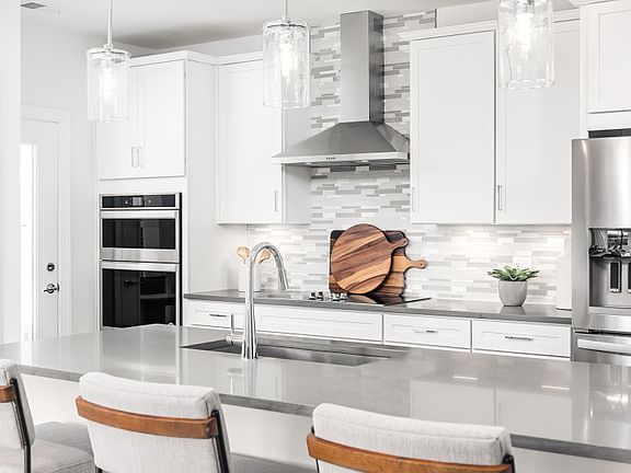 Quartz Countertops and White Cabinetry in the Gourmet Kitchen