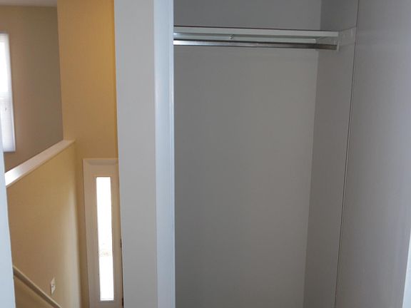 Coat closet at top of stairs