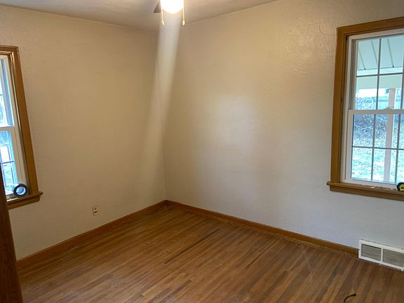 Bedroom 2 hardwood with closet and ceiling fan.