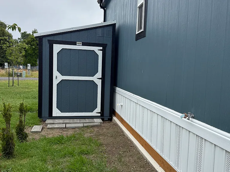 storage shed on side of home