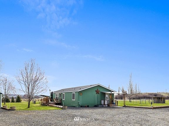 Home, detached garage/shop and covered parking with large span of driveway for ease of vehicle movement.