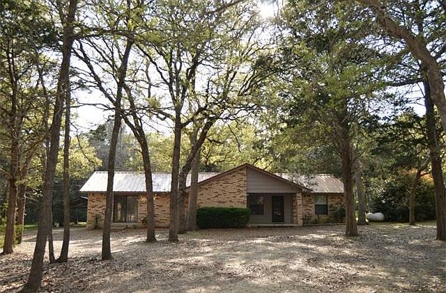Park like setting.Woods are to the left of the property. Located on quiet Cul-de-sac. Covered porch . Property is almost an acre. Home is warm and inviting