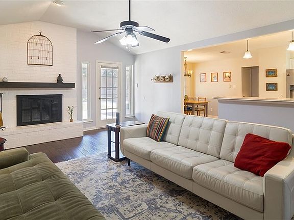 A view of the family room which is open to the kitchen and the breakfast area.  Pendant lights over the breakfast bar.