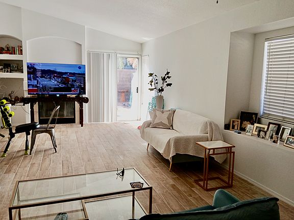 Living Room with Vaulted Ceiling Leads to Backyard