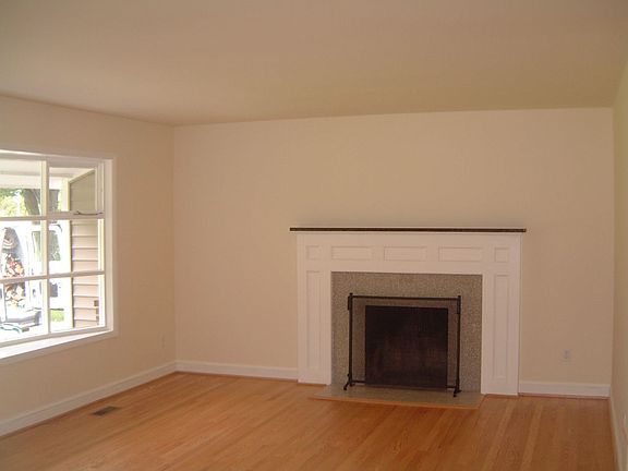 Spacious living room w/Bay window & Granite wood burning fireplace!