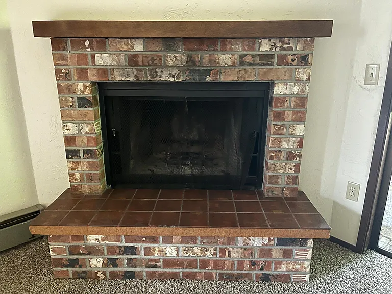 Wood burning fireplace for secondary/ emergency heat only. Home has cozy radiant electric heat panels in all rooms. Unit is completely electric.