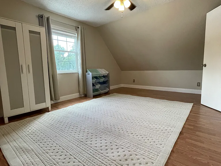 third bedroom with closet and armoire.