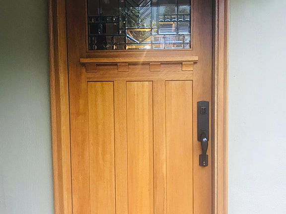Craftsman style wood door with stained glass.