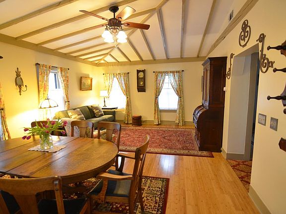 Vaulted ceiling with beam in dining room and living room