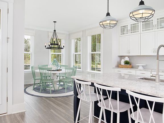 The kitchen flows into the cafe area and the Great Room