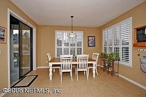 dinette, sliding glass doors overlook summer kitchen in yard